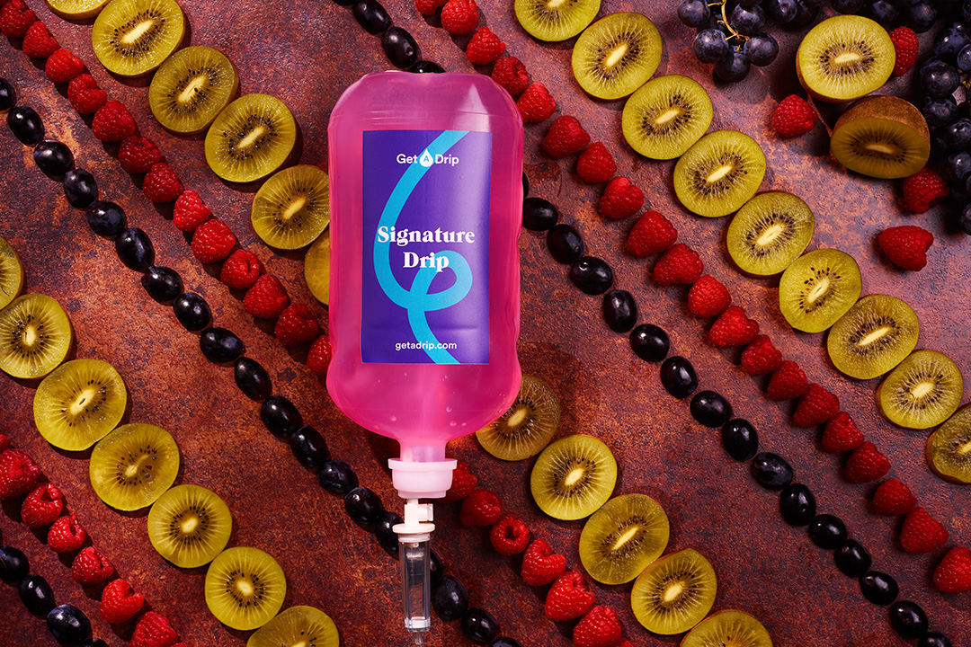 Signature vitamin drip surrounded by fruits